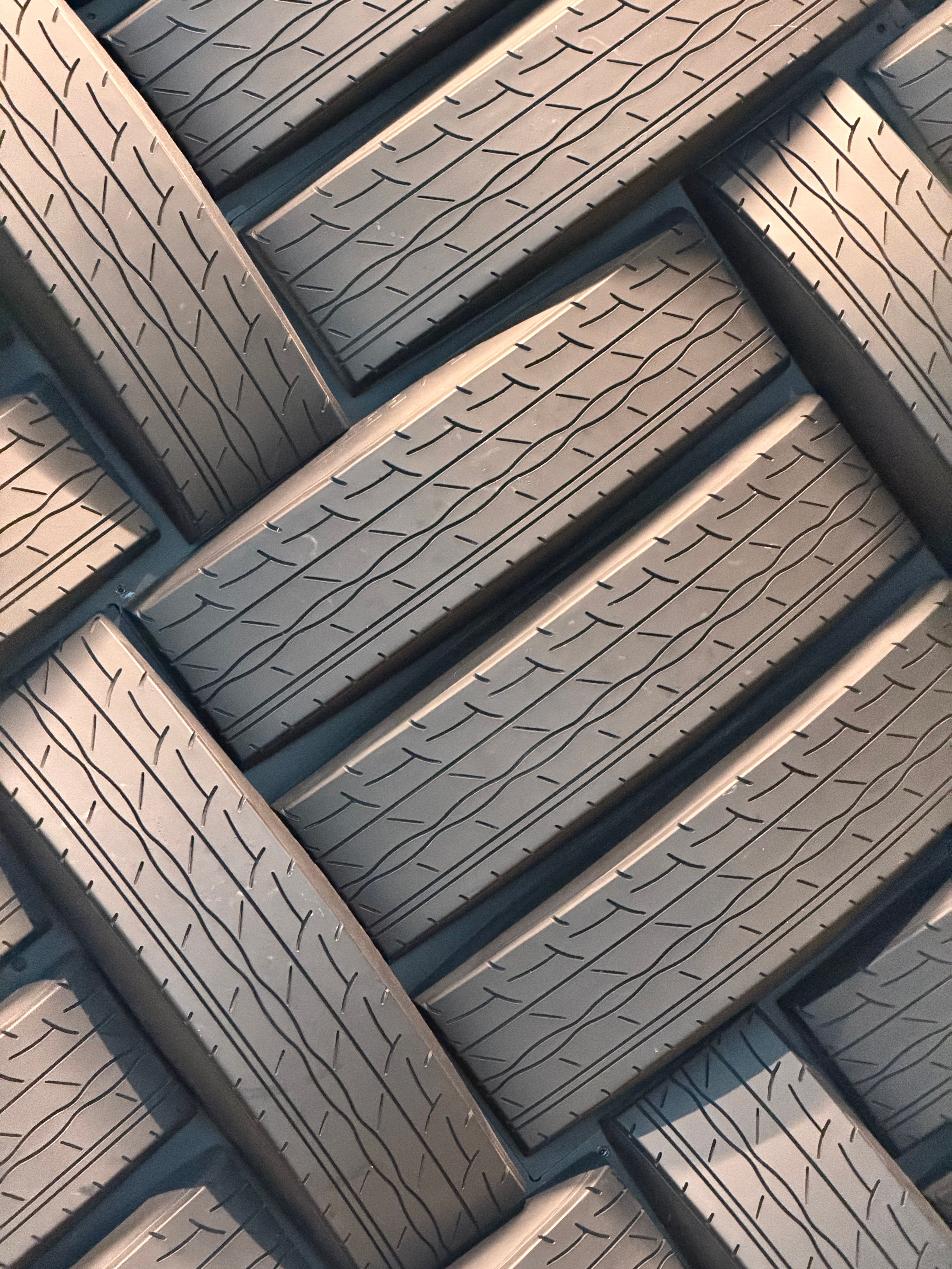 Intriguing abstract composition of stacked tires forming a geometric pattern, highlighting texture.