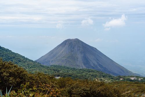 Free Discover the breathtaking beauty of Izalco Volcano in El Salvador with lush greenery and clear skies. Stock Photo