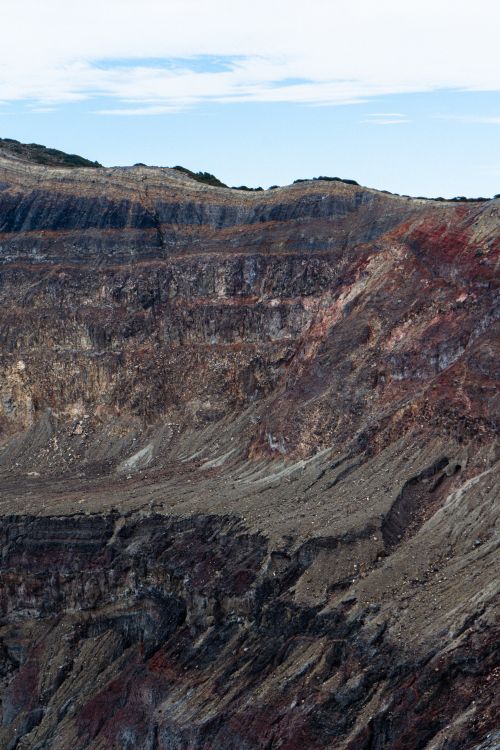 Free A stunning view of a multi-layered volcanic crater with rich earthy tones and textures. Stock Photo