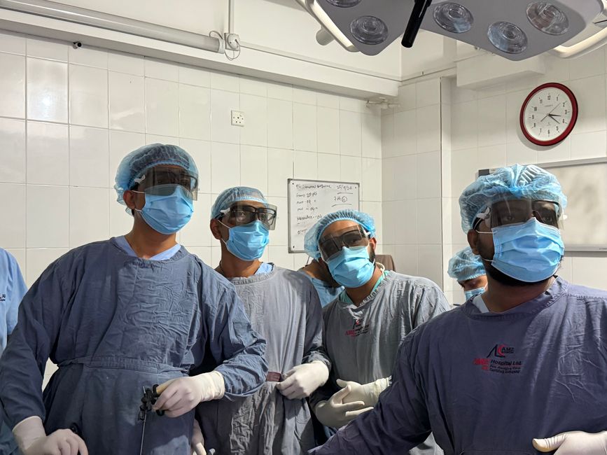 A team of surgeons in a Dhaka hospital working in a sterile operating room setting.