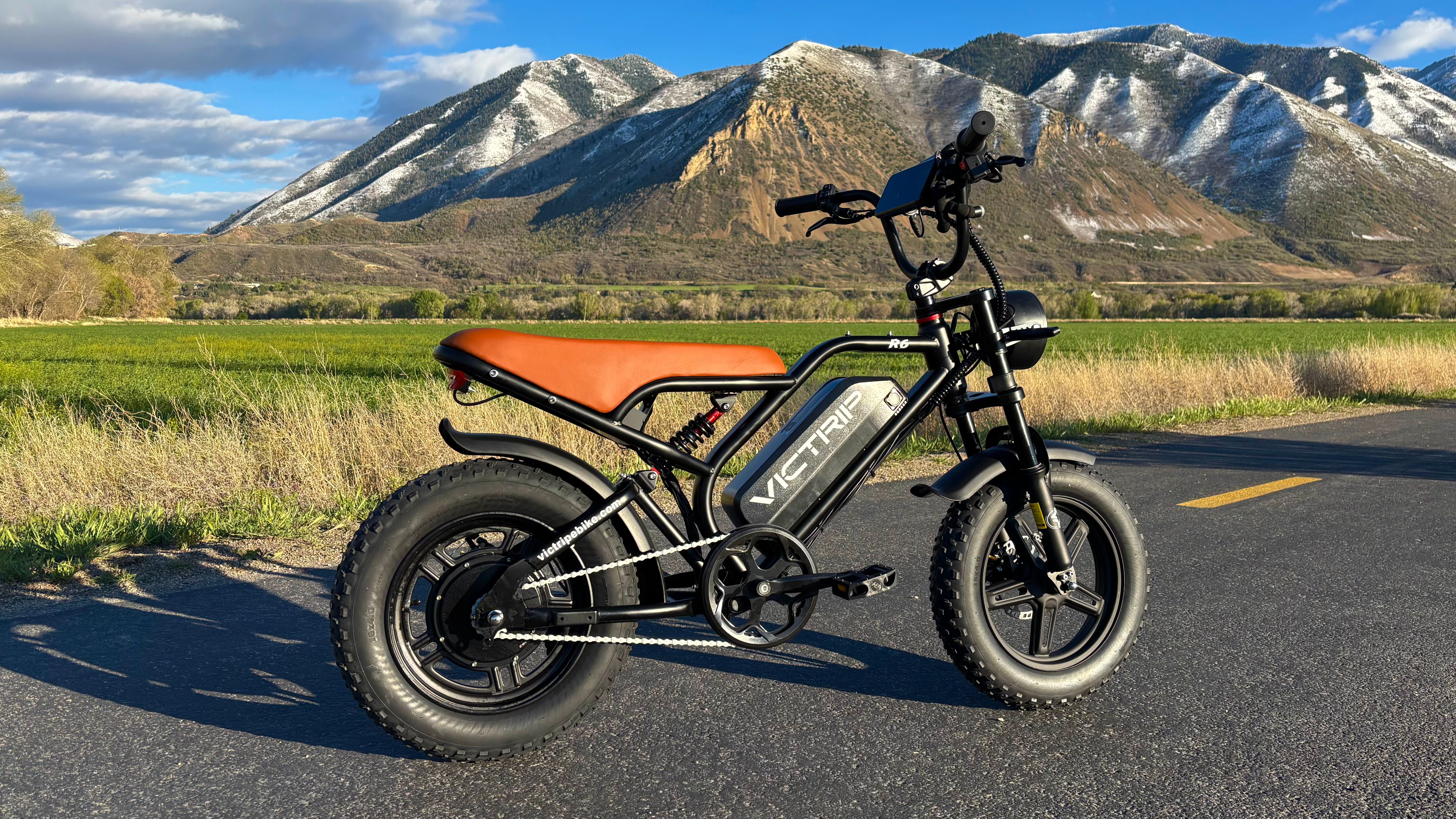 Electric bike parked on scenic road with mountain backdrop in Utah.