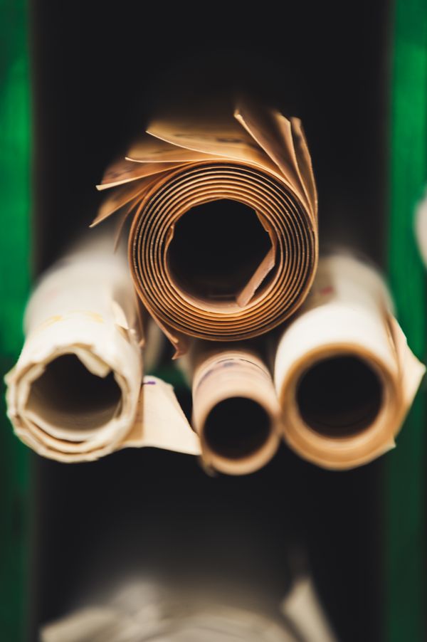 Stacked kraft paper rolls and packaging material at Salasar Papers