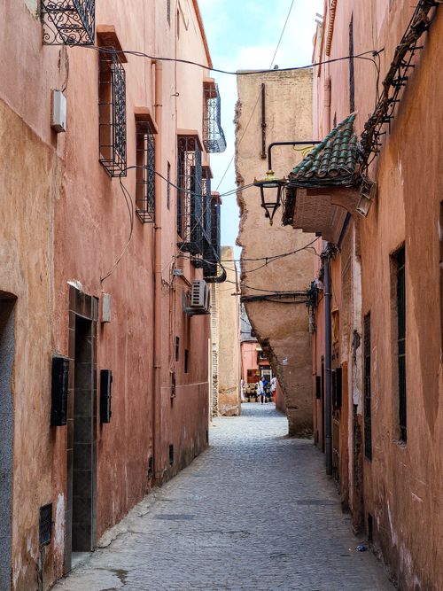 Free Charming narrow alleyway in the historic Medina of Marrakesh, Morocco, with peach-colored buildings. Stock Photo