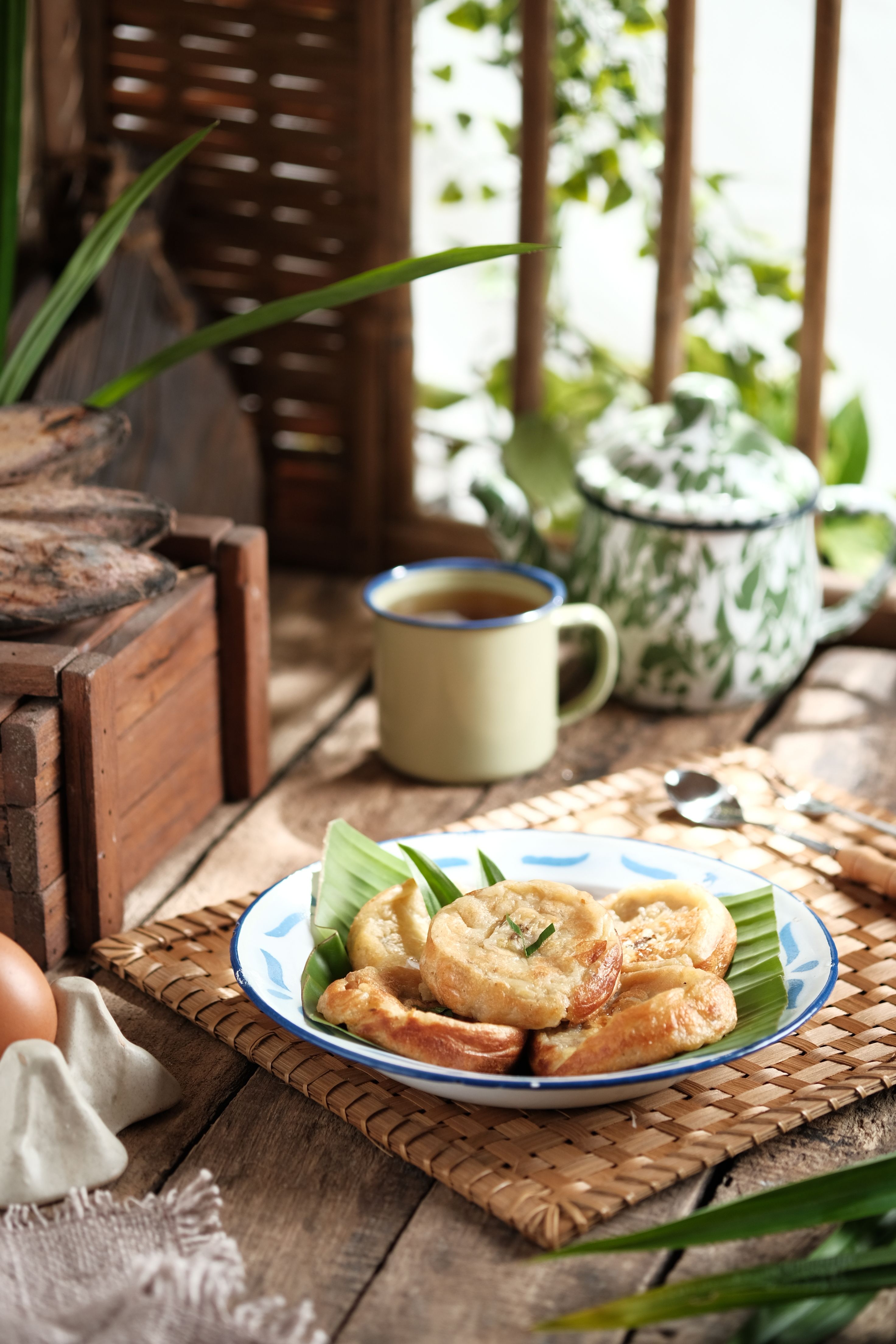 Indonesian traditional snack served with tea in a rustic setting in Jakarta.