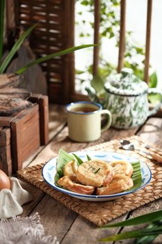 Indonesian traditional snack served with tea in a rustic setting in Jakarta. - Fotografer Sidoarjo