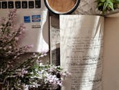 Pink Flowers Beside White Notepad with Handwritten Text