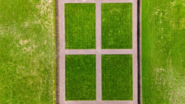 Aerial shot of symmetrical sports fields, showcasing vibrant green grass in Jönköping, Sweden.