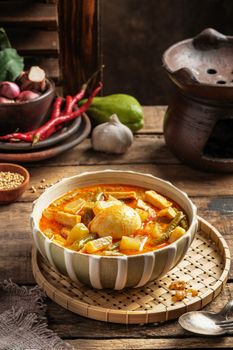 A bowl of flavorful Lontong Sayur with vegetables and egg, showcasing Indonesian cuisine.