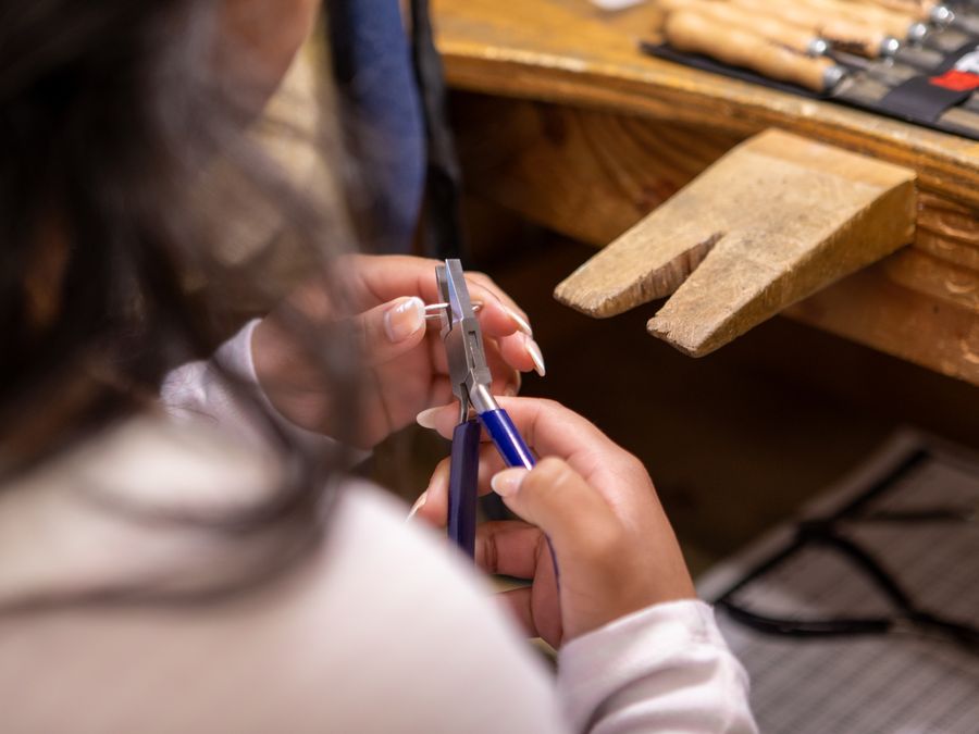 Craftsperson using pliers in a workshop