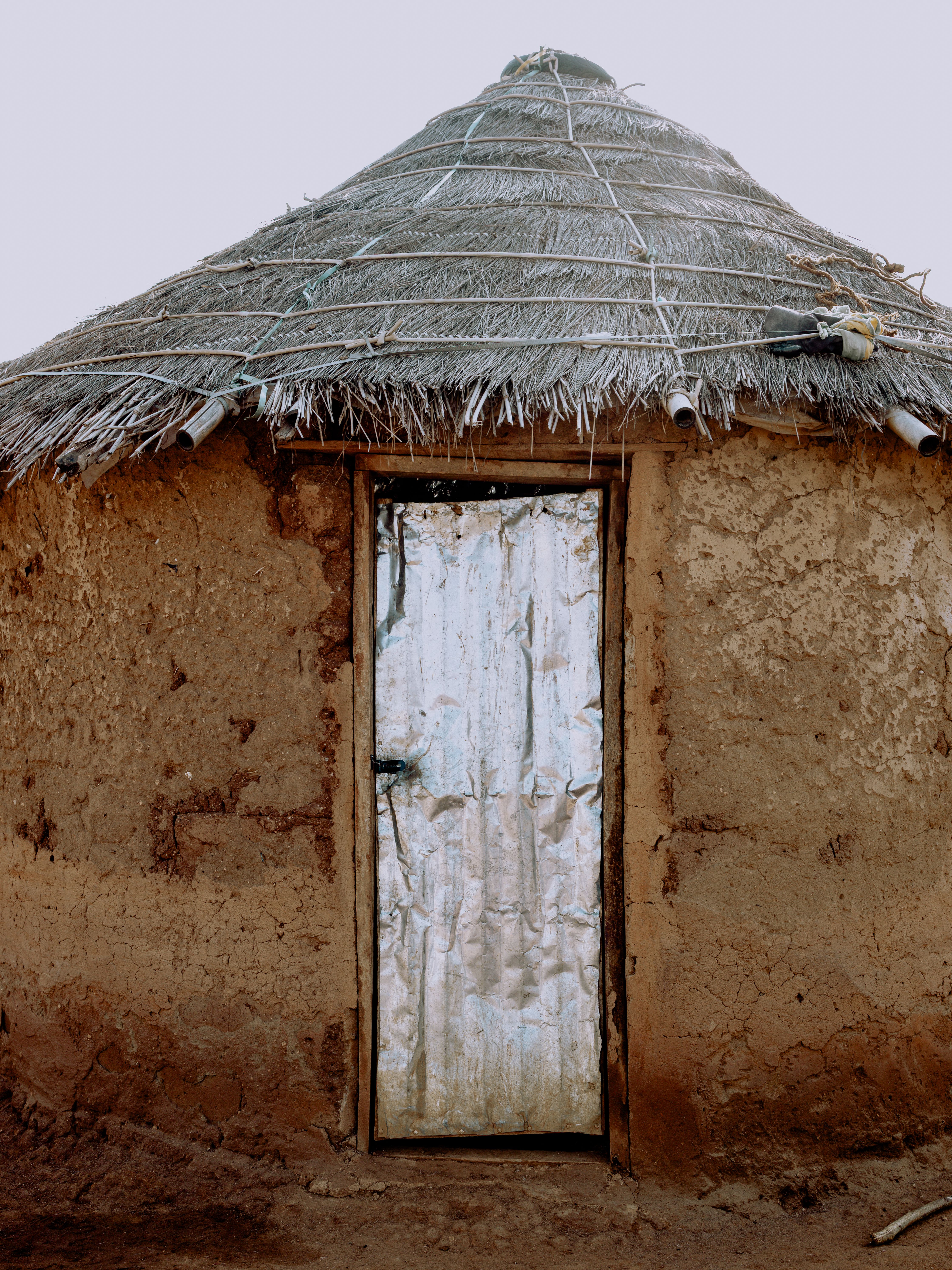 Traditional mud hut with thatched roof, Togo