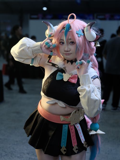 Free Vibrant anime cosplay captured at a Vietnamese convention, featuring detailed costume and accessories. Stock Photo