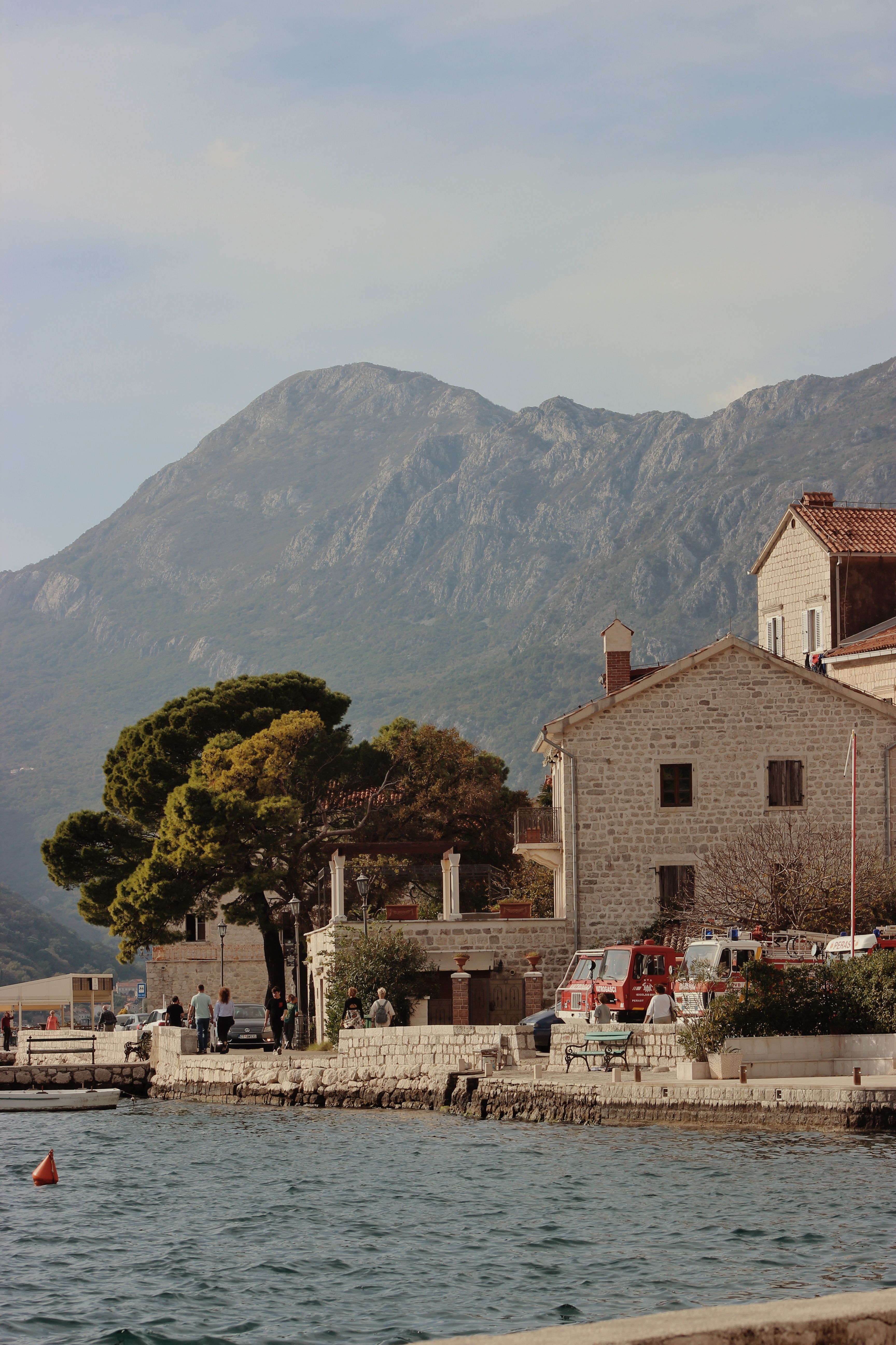 Picturesque coastal village of Karadağ with mountain and serene waterfront setting.