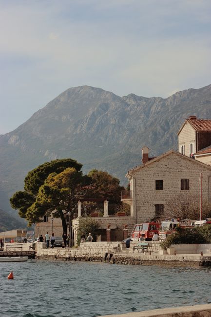 Picturesque coastal village of Karadağ with mountain and serene waterfront setting.