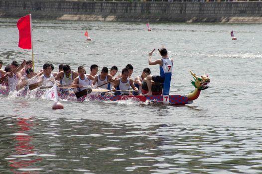 Exciting dragon boat race on Shing Mun River, Hong Kong showcasing teamwork and tradition.