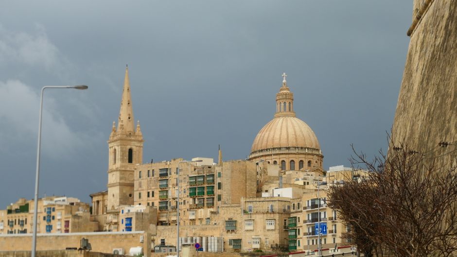 Historic street in Valletta, Malta, on a mild winter day with a hint of recent rain