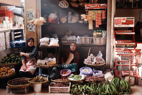 Free Two women selling vegetables and spices in Jogja market, Indonesia. Stock Photo