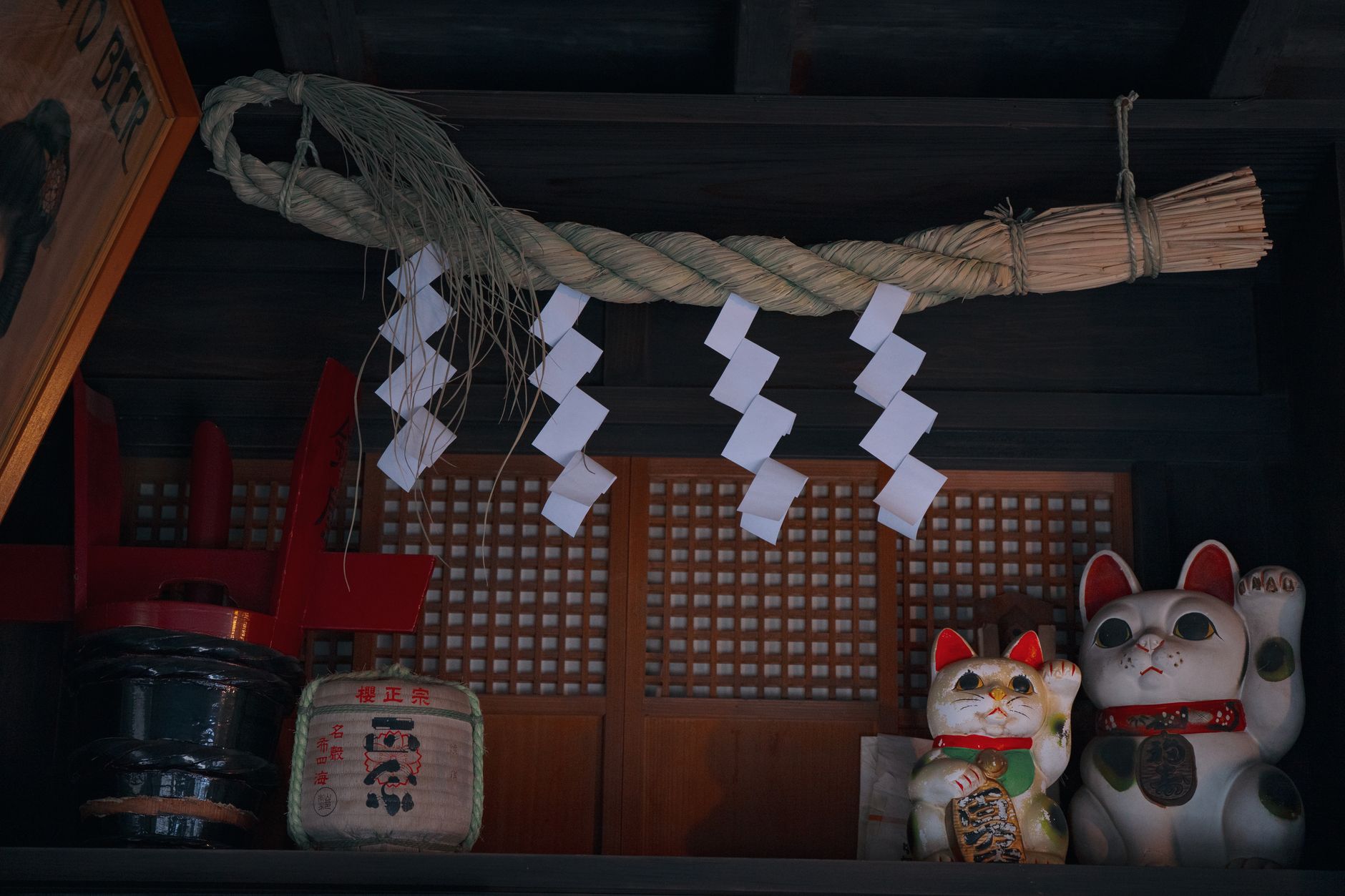 Japanese shrine decor with lucky cat statues and sacred rope in Tokyo, Japan.