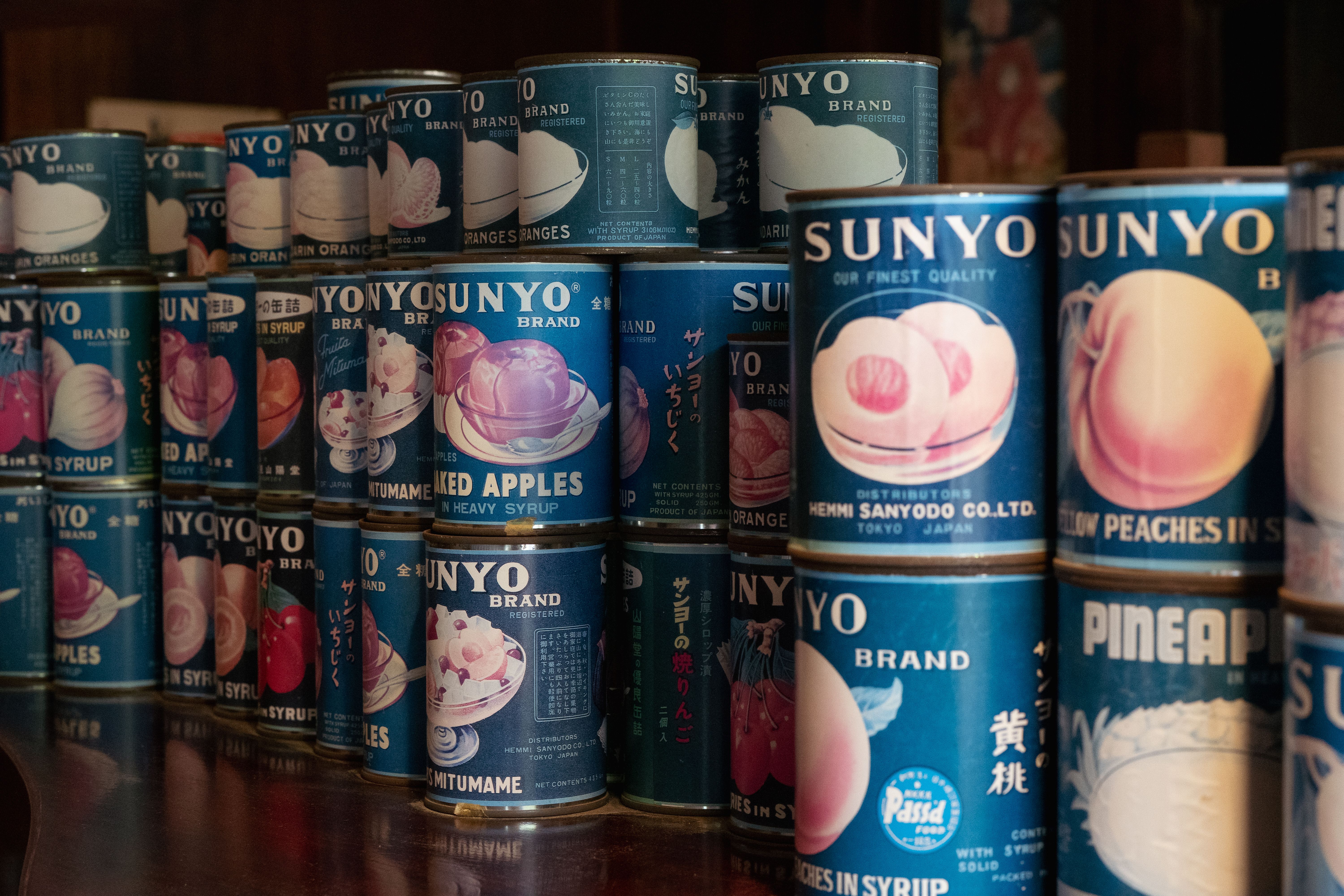 A nostalgic collection of vintage Sunyo canned fruit labels in a Tokyo shop.
