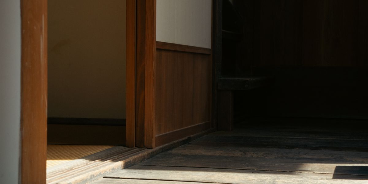 Zen-inspired minimalistic Japanese room featuring wooden panels and tatami mats.