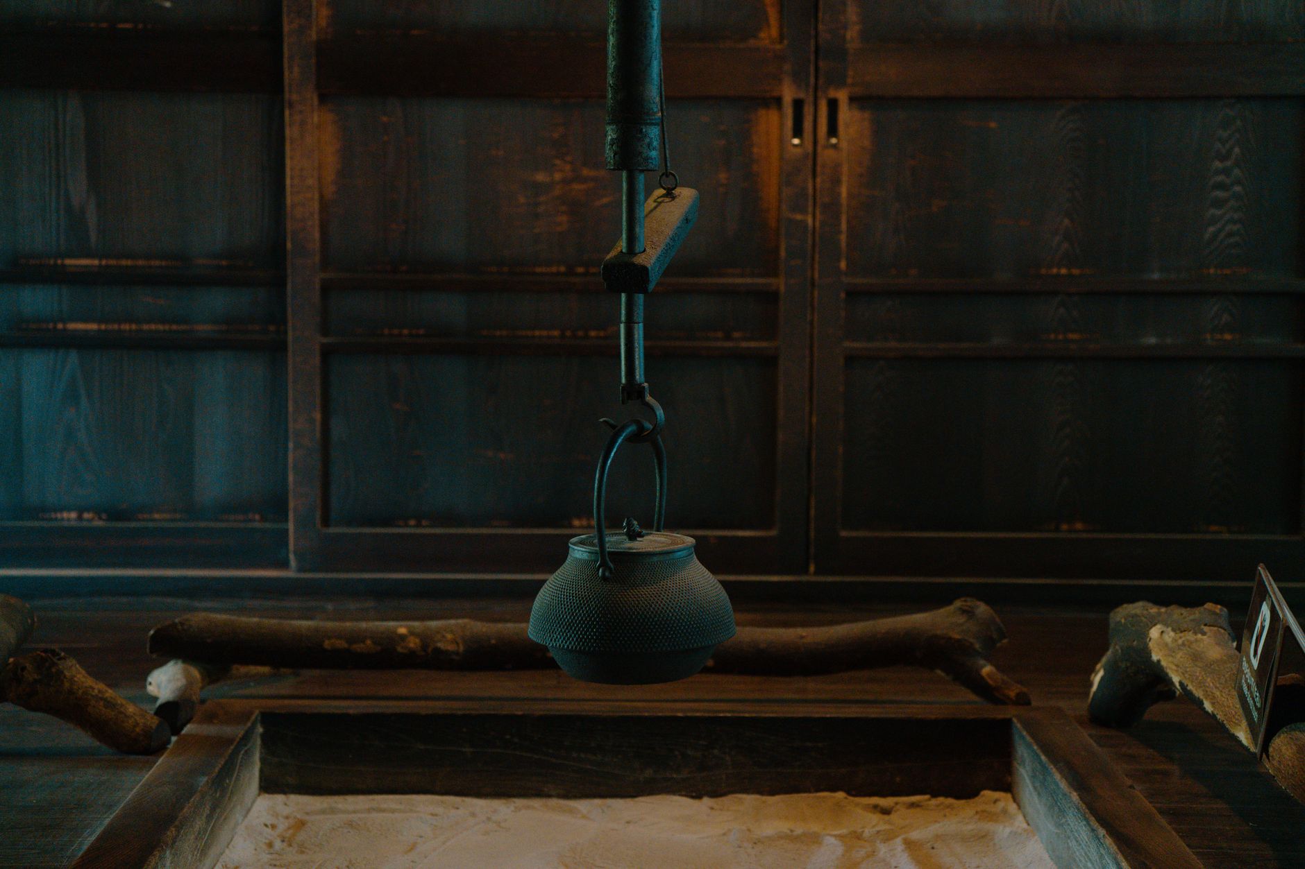 Best Tokyo Tea Ceremony Experiences for Travelers Cozy interior featuring a traditional Japanese hearth with a cast iron kettle in Tokyo, Japan.