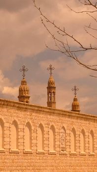 Historic stone church towers with crosses against a dramatic sky.