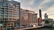 夕阳的金色天空映照着伦敦现代河畔的建筑