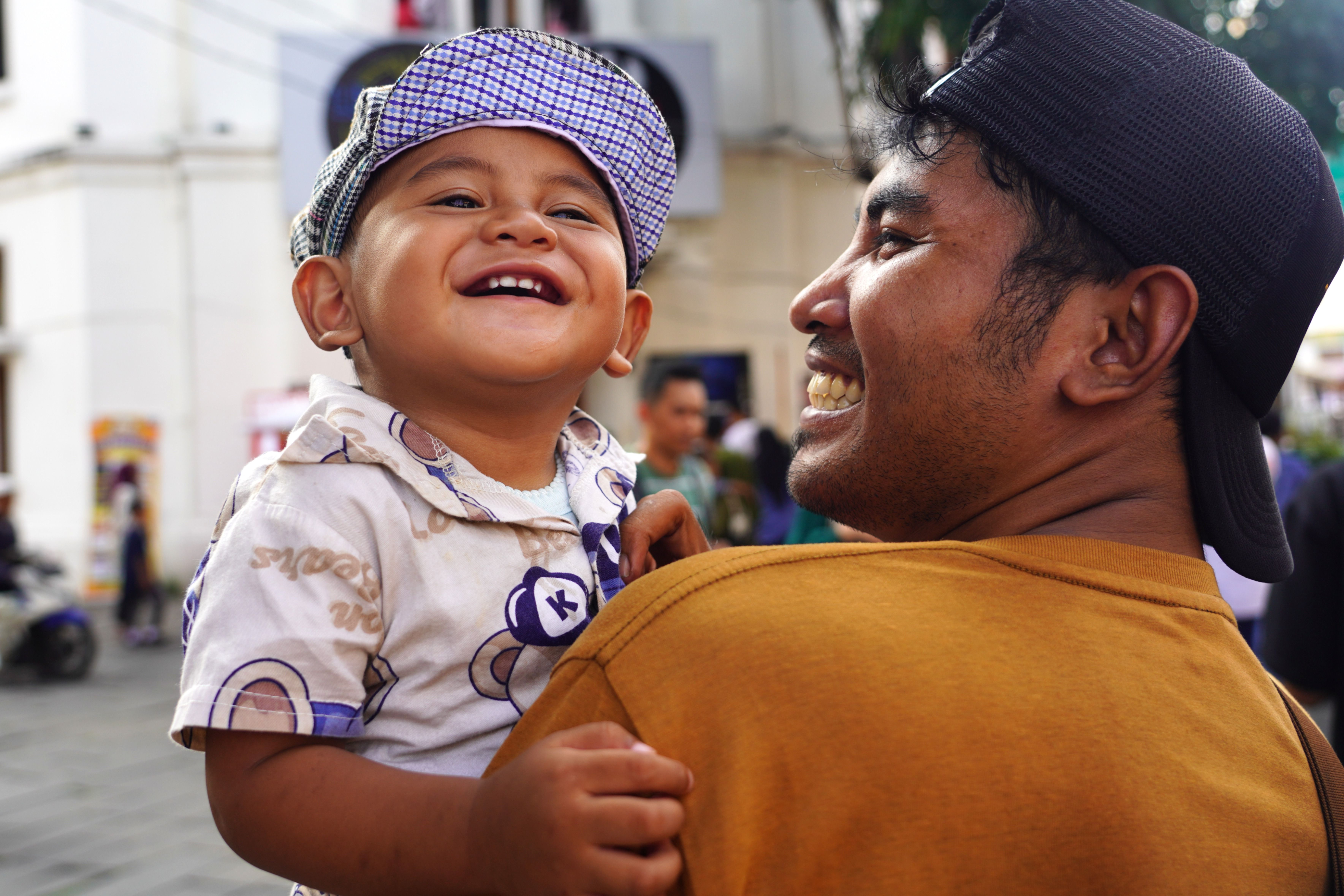 Father and child enjoying a joyful moment outdoors, showcasing happiness and bonding.