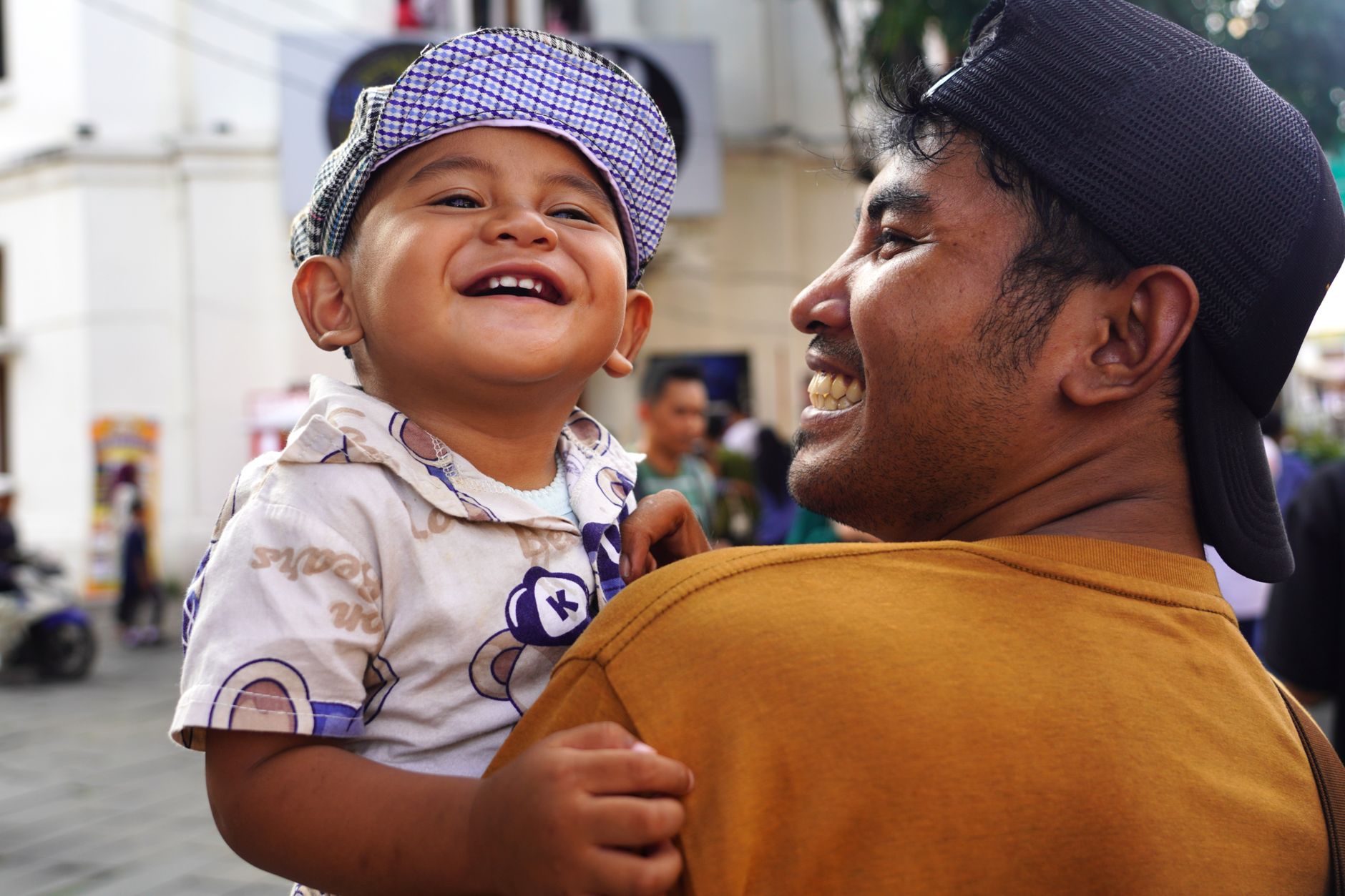 Father and child enjoying a joyful moment outdoors, showcasing happiness and bonding.