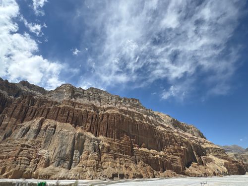 Free Stunning view of a massive rock formation beneath a vivid blue sky in Nepal's Mustang region. Stock Photo