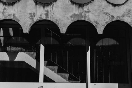 Free Minimalist black and white photo of arches in urban architecture, shadows casting patterns. Stock Photo
