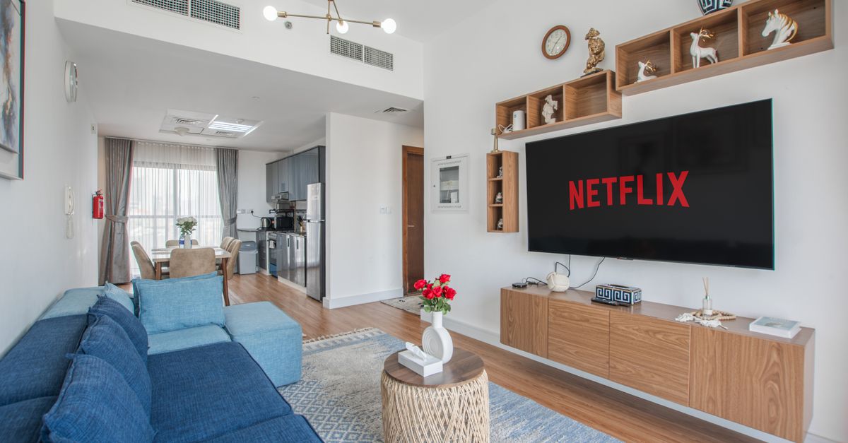 Netflix logo on television screen in dark living room