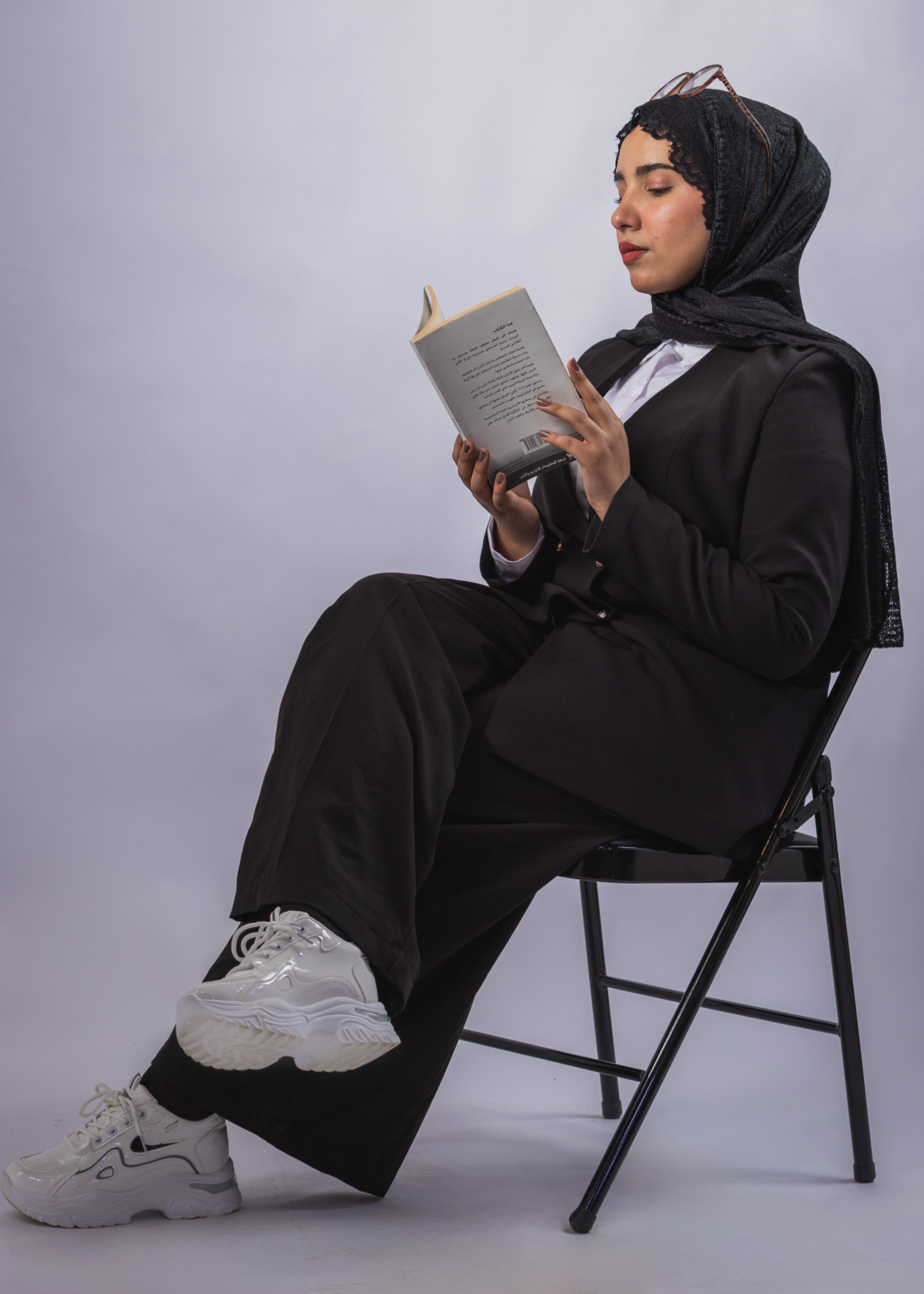 Young Woman in Hijab Reading a Book Indoors · Free Stock Photo