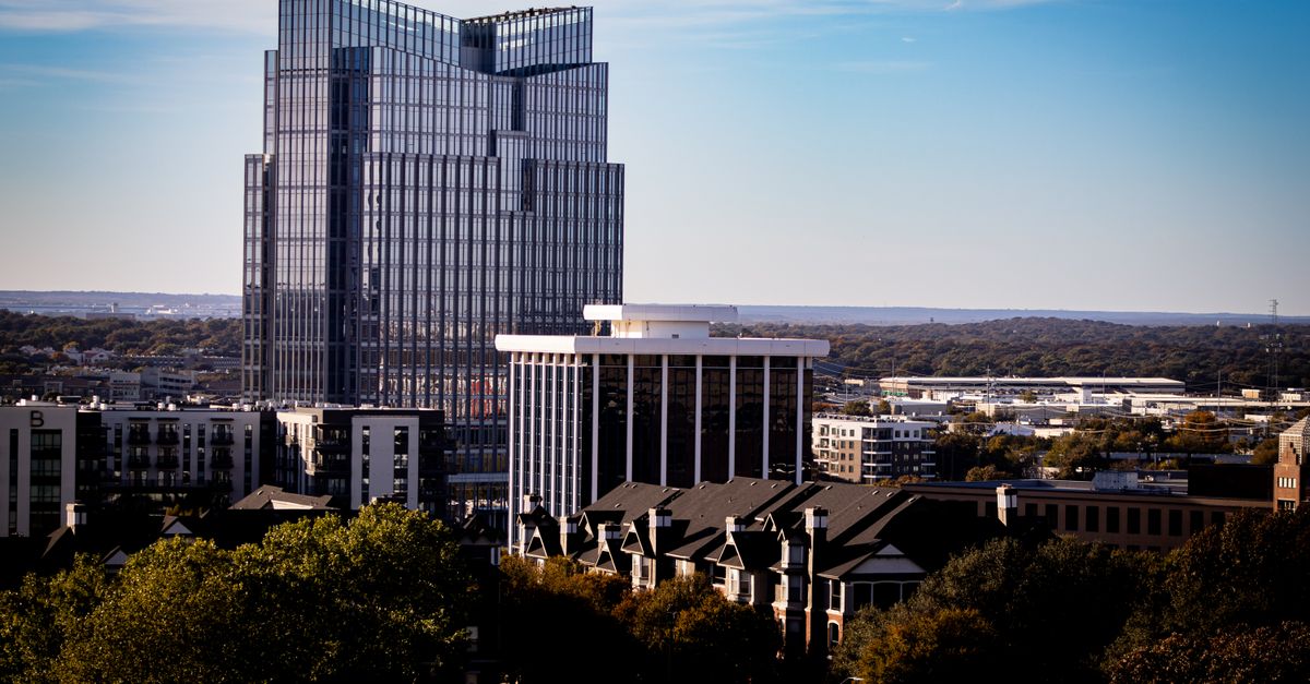 A view of Fort Worth's modern skyline with the prominent Frost Tower under a clear blue sky.