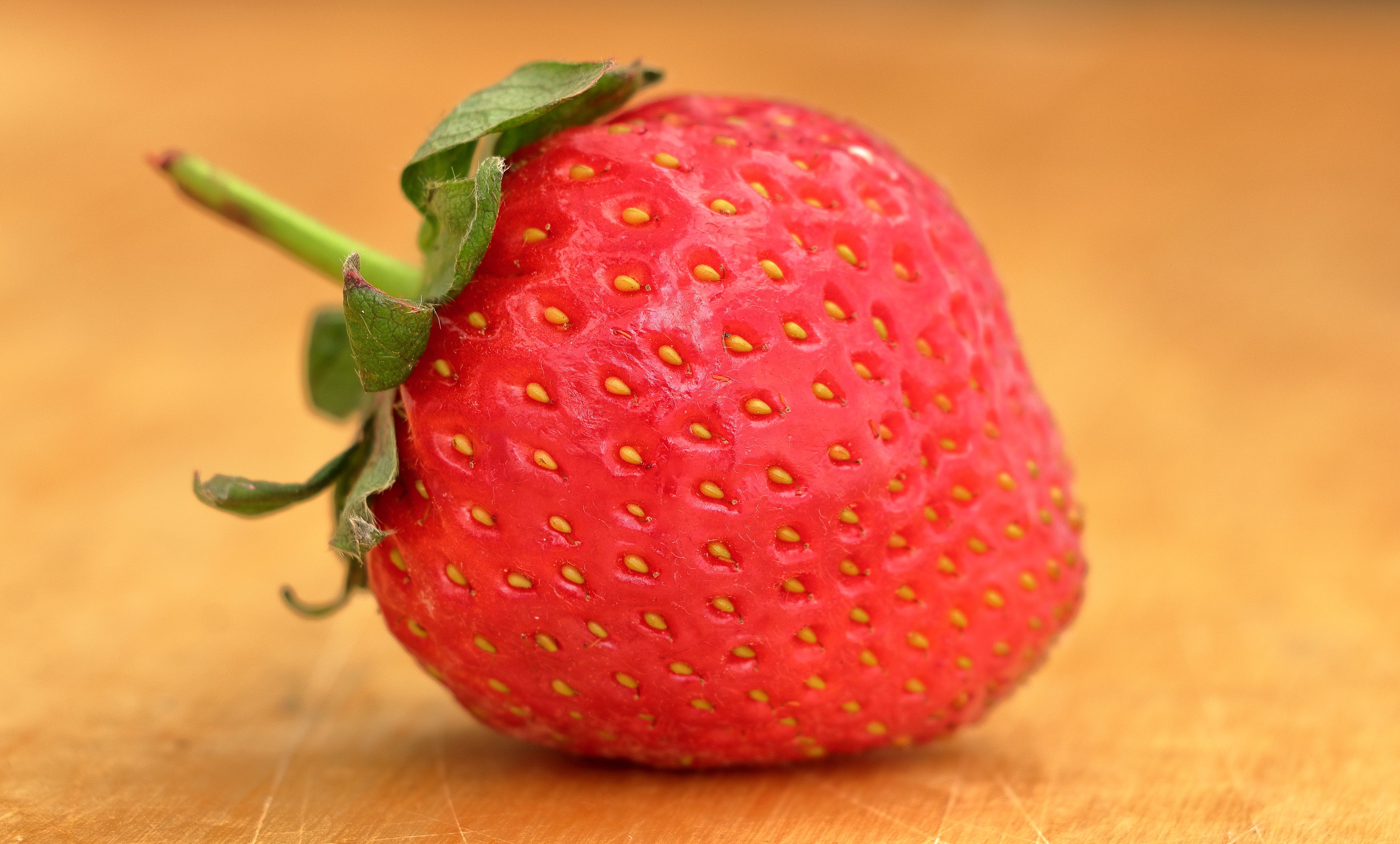 Close-up of Fresh Ripe Strawberry on Wooden Surface · Free Stock Photo