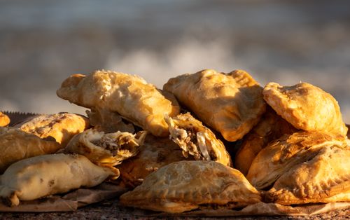 Free Golden baked empanadas filled with meat, placed by the seaside in Montevideo, Uruguay. Stock Photo