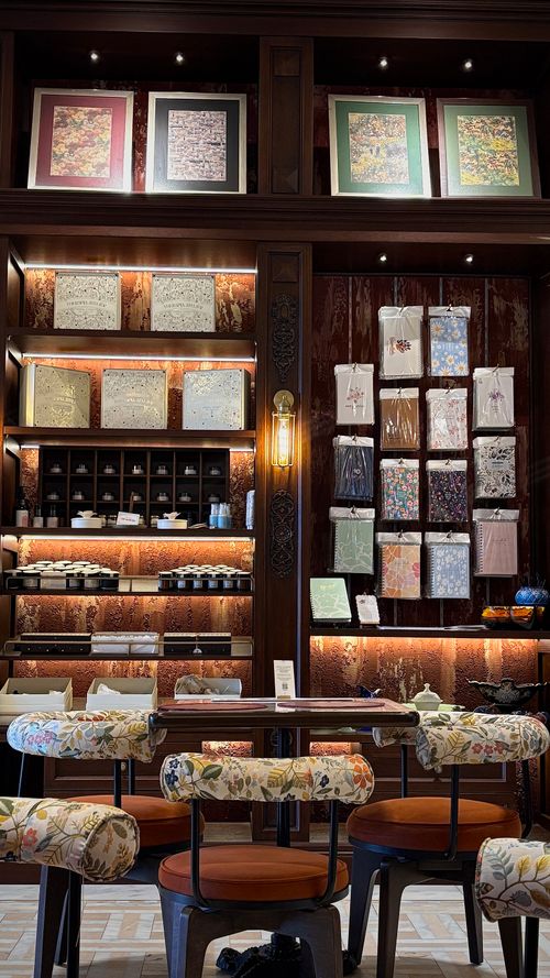 Free Stylish tea shop with decorative shelves and cozy seating in a warm ambiance. Stock Photo