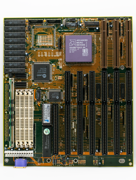 Close-up of a retro computer motherboard highlighting a CPU and multiple RAM slots.