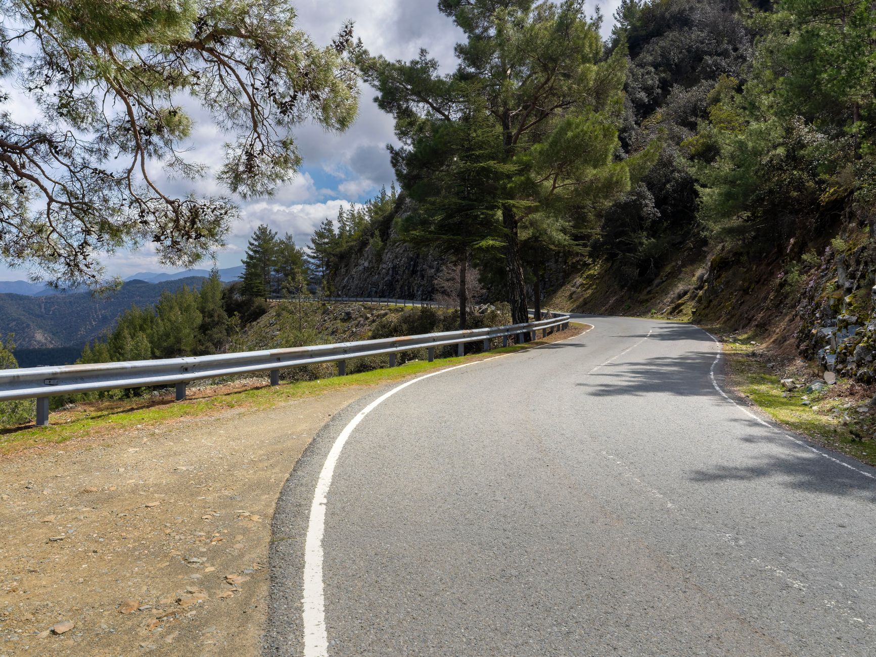 Captivating view of a winding road through Troodos mountains, Cyprus, showcasing lush nature. — photo by Bob Jenkin / Pexels