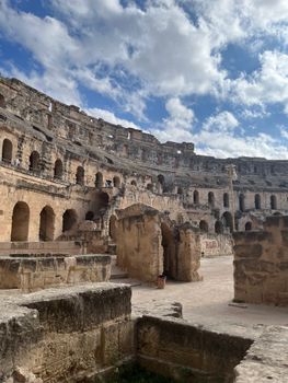 Capture of the ancient El Jem amphitheater in Tunisia, showcasing its grandeur under a bright blue sky.