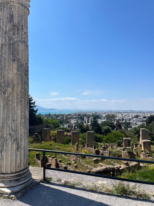 Free Explore the ancient Roman ruins of Carthage with a stunning view of the Tunisian coastline under a clear blue sky. Stock Photo