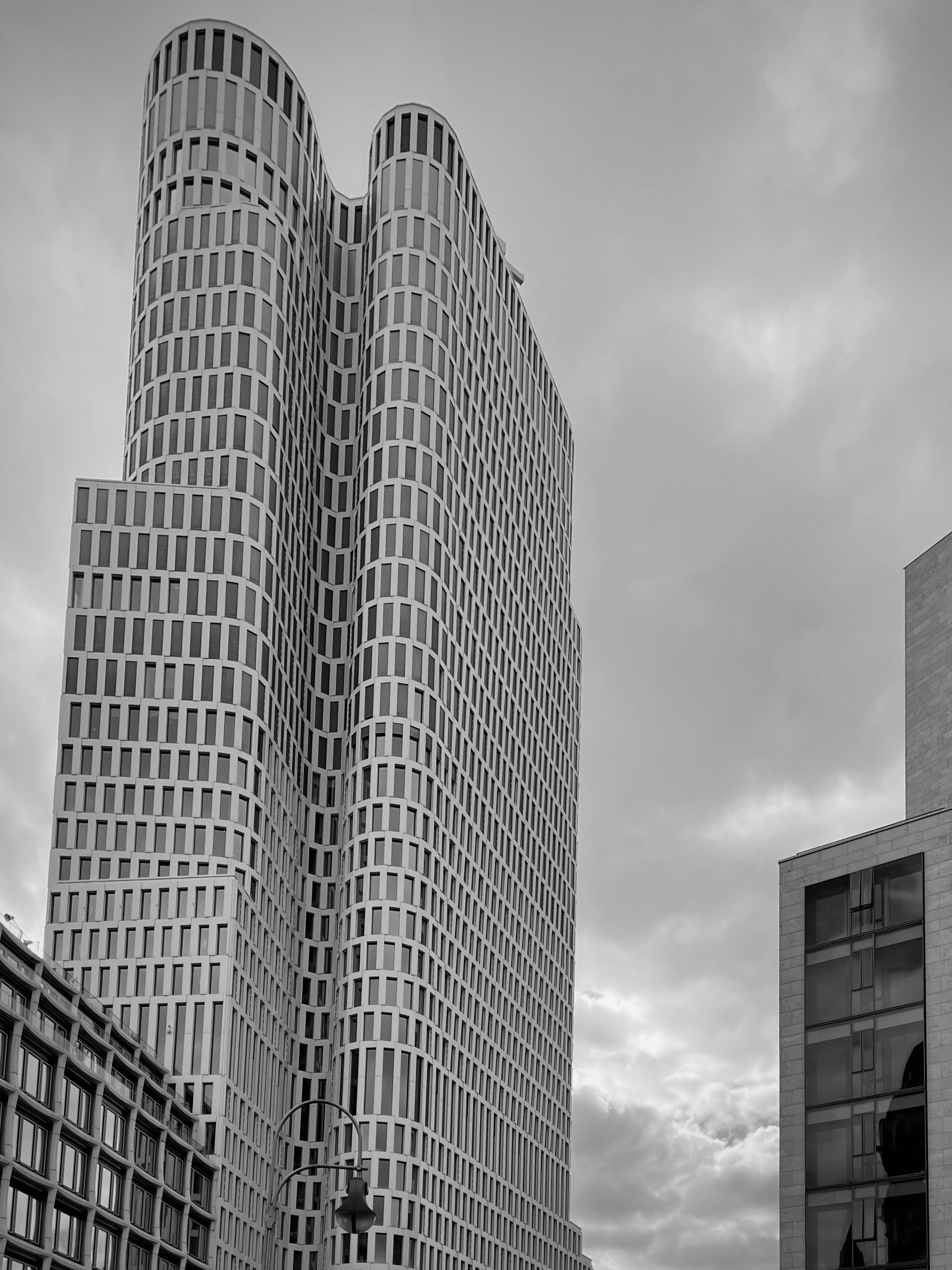Modern Skyscraper Against Cloudy Berlin Sky · Free Stock Photo