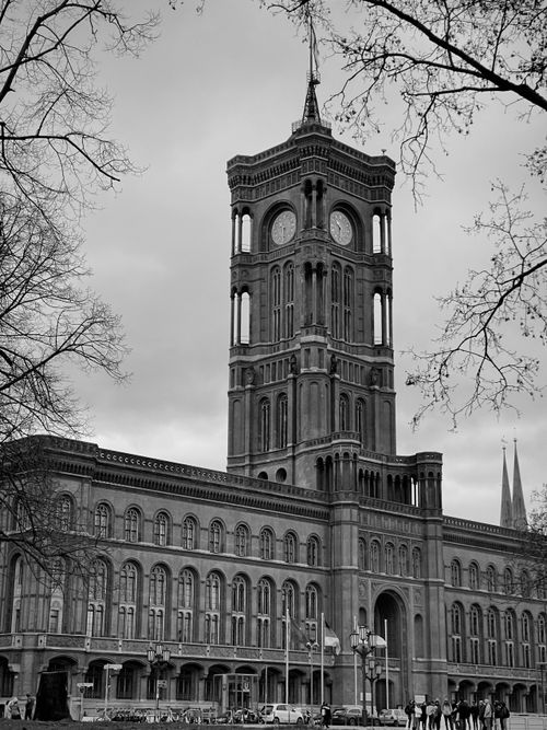Free A black and white photo of the iconic Rotes Rathaus in Berlin surrounded by bare trees. Stock Photo