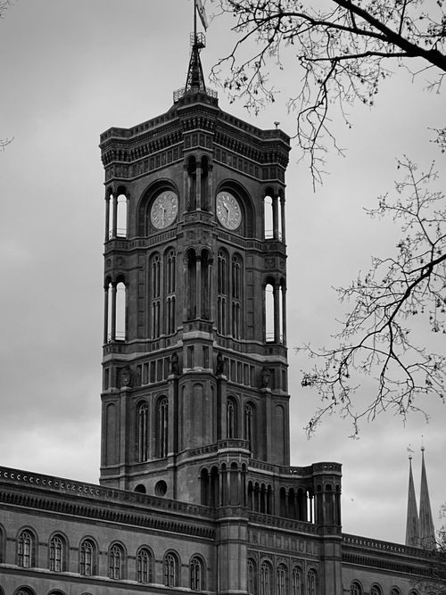 Free Majestic black and white photo of Berlin's iconic Rotes Rathaus tower under a cloudy sky. Stock Photo
