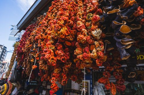 Free Colorful dried vegetables hanging at a traditional market in İzmir, Türkiye. Stock Photo