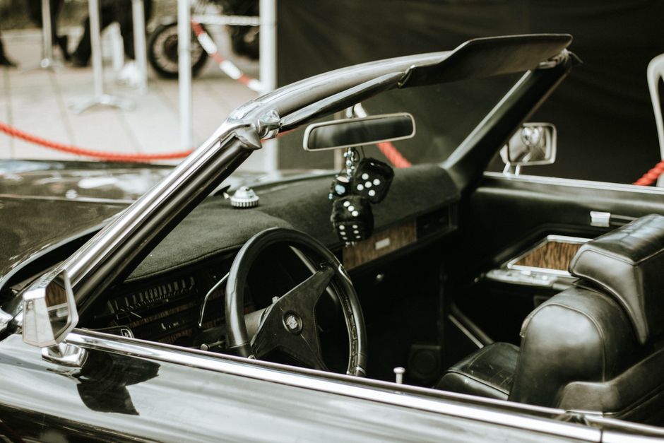 Interior view of a vintage convertible car showcasing classic design and style at a car show.