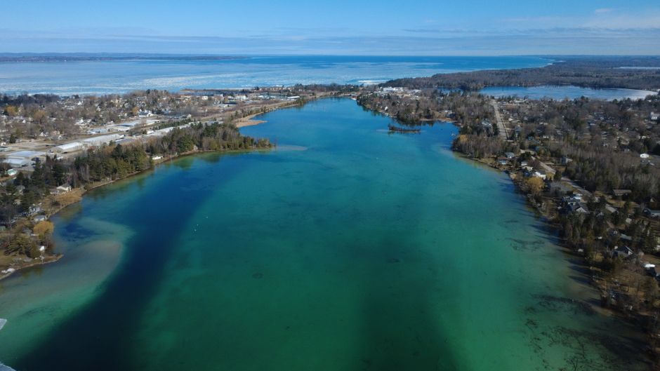 Aerial view of Torch Lake in Northern Michigan with vibrant blue-green water