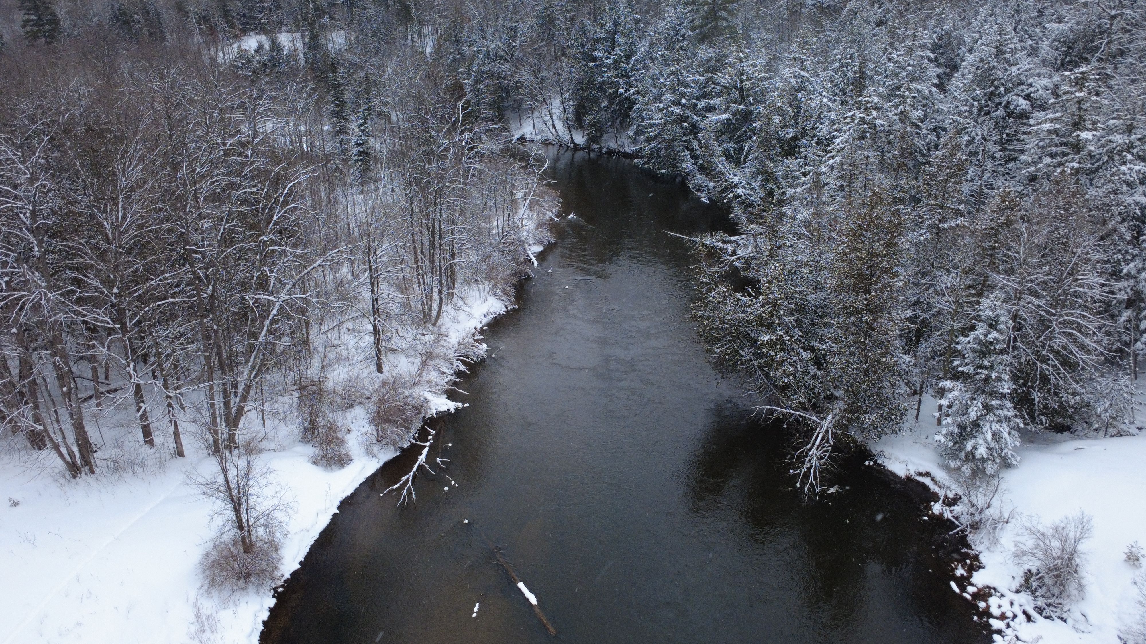 Aerial View of Snow-Covered Winter River Scene · Free Stock Photo