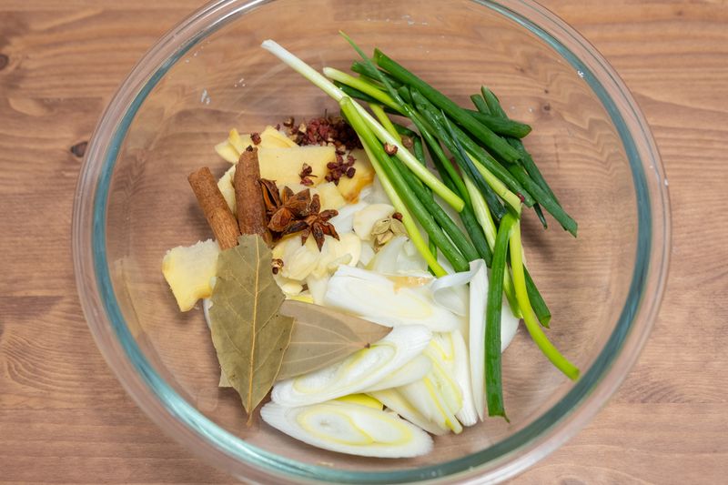 A vibrant blend of Asian spices and herbs in a glass bowl, perfect for gourmet cooking.