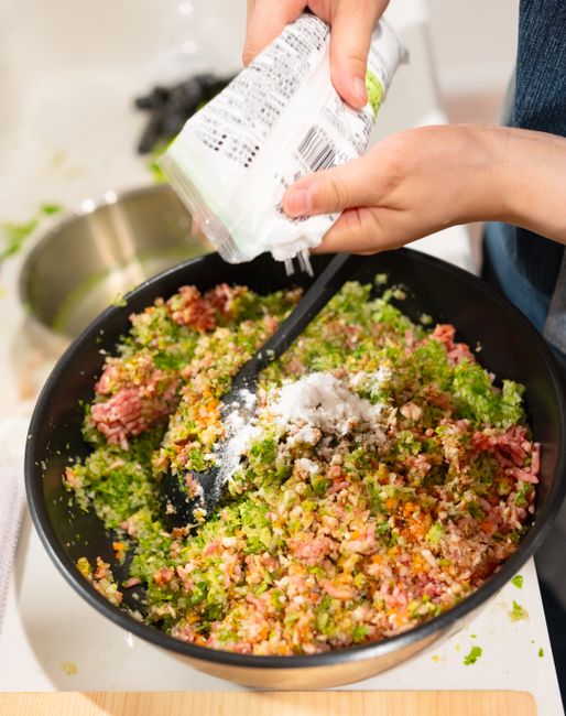 mixing kimchi by hand
