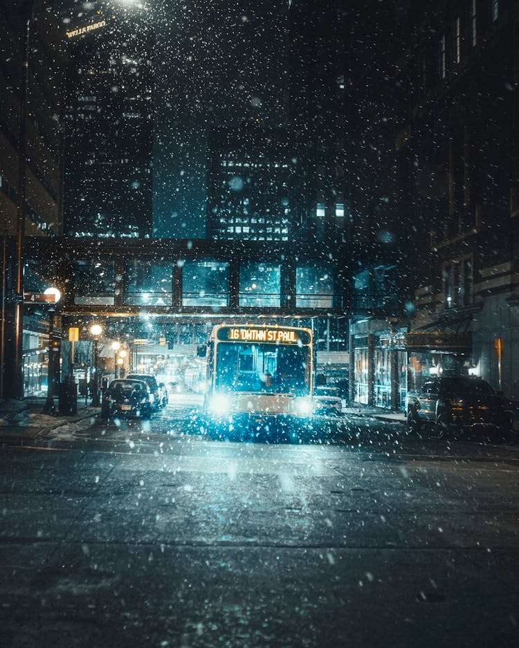 Bus With Lights On At Snowy Night